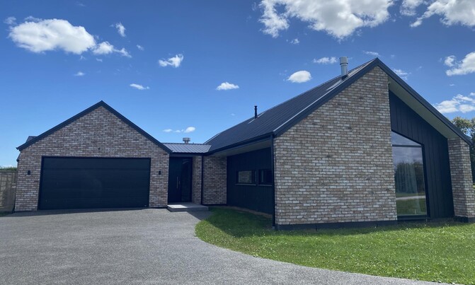 Modern brick house has natural tones mix of dark exterior that makes this house distinctive and one-of-a-kind