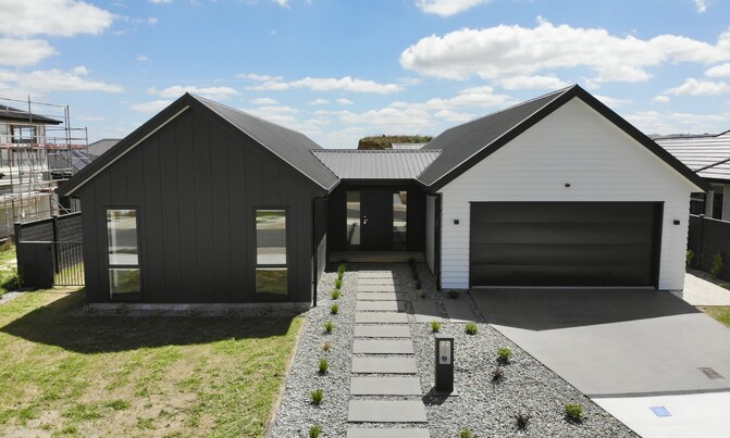 Bespoke black and white exterior makes this new pavilion-style home easy to create dedicated spaces for families