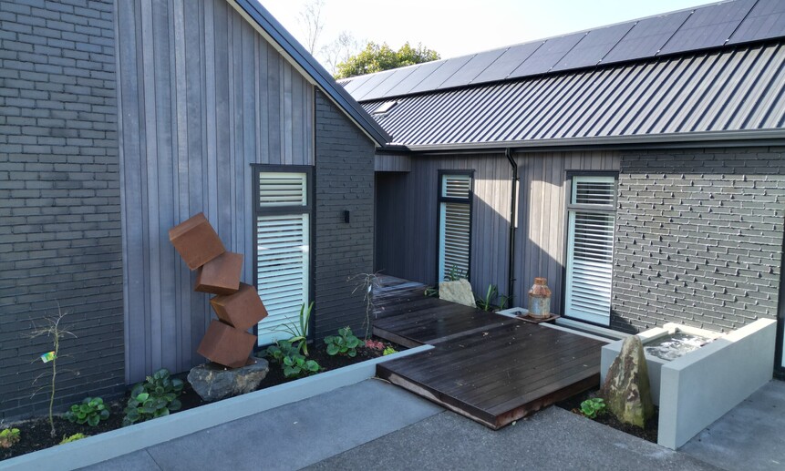 Cambridge builders Linecest Homes have built a unique entrance that features a sculpture, water feature and low level deck. 