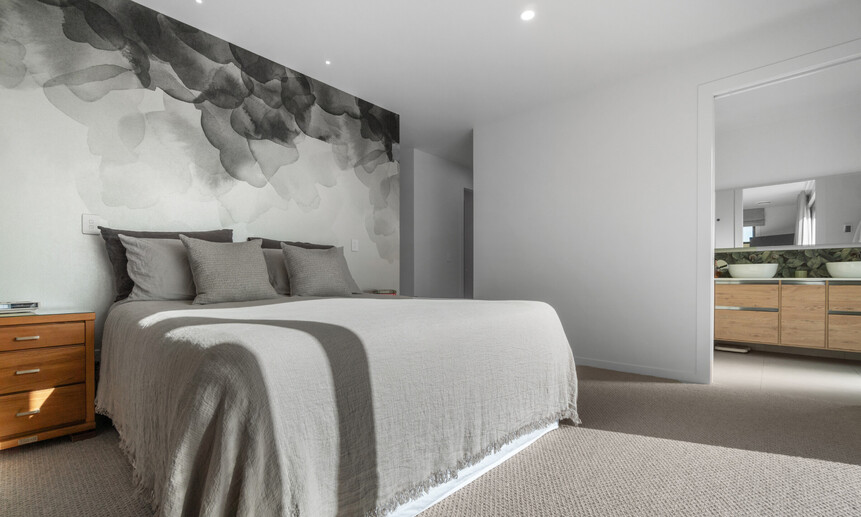 The master bedroom has a feature wall that is both minimal and elegant in this award-winning home built by Linecrest Homes.