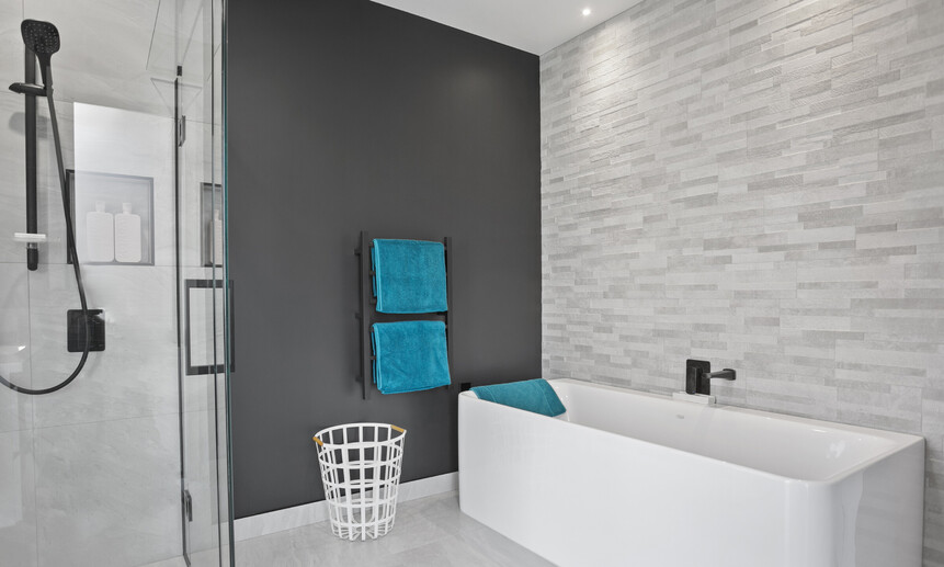 This offset-tiled feature wall in the high-end bathroom creates a relaxing feel and is designed with purpose.