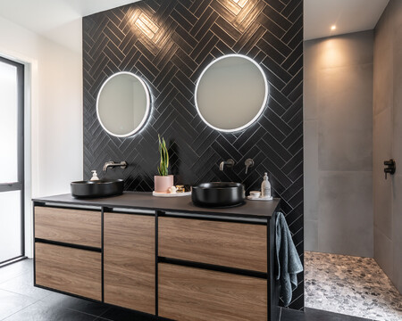 Luxury black bathroom with wood tones creates a deeply relaxing, cocoon-like feel in this awarding-winning new house build