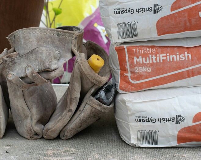 Paintbrush and plaster for plastering services