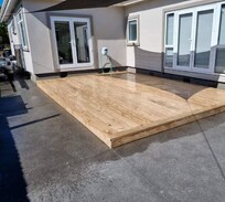 Low-profile timber deck installed over concrete for a clean, modern look – built by professional deck builders in Christchurch.