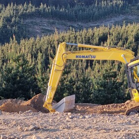 Komatsu digger working on a hillside excavation site in Canterbury – expert earthmoving contractors North Canterbury.