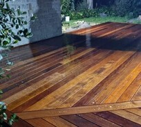 Custom hardwood deck with chevron board pattern under covered outdoor space – expertly finished by deck builders in North Canterbury.