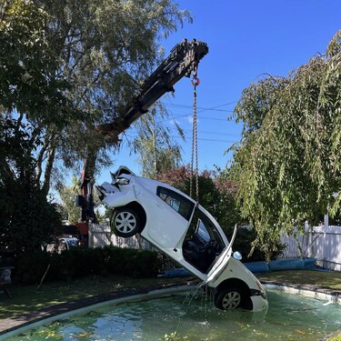 Car being lifted by Williams salvage from a swimming pool