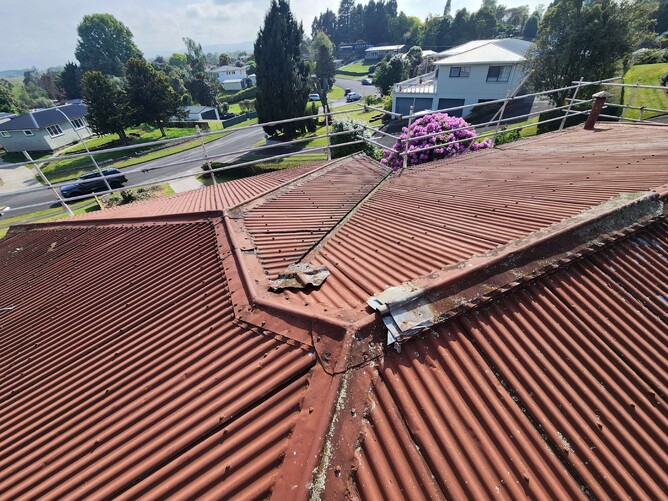 Rusty flashing detail needing repair on tiled roof