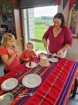 Michelle cutting cake and serving to kids