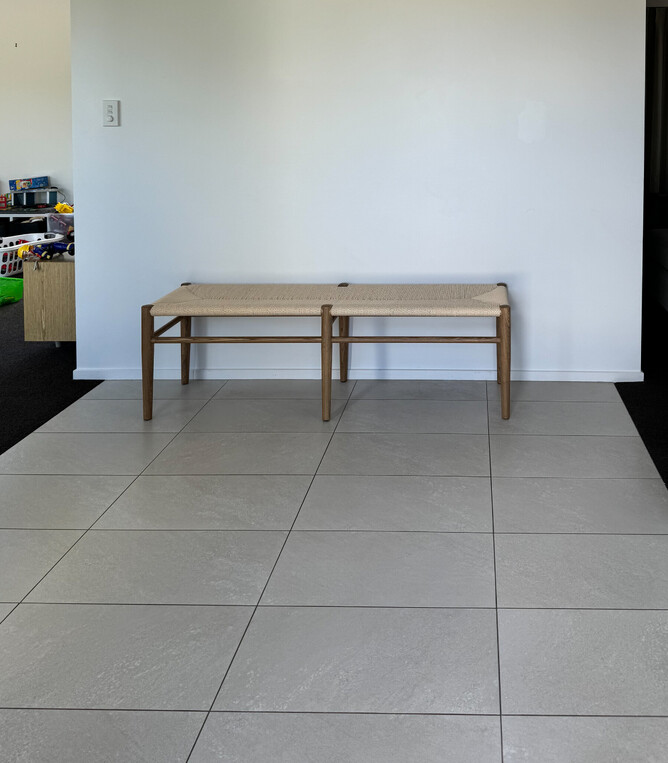 BEFORE: Entranceway with tile floor and dark carpets into the living areas created a dated look, which was impractical for a high-walk through area.