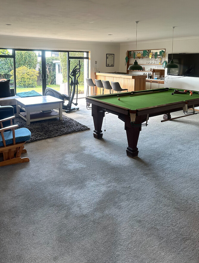 BEFORE: Carpet in rumpus room make the space feel darker.
