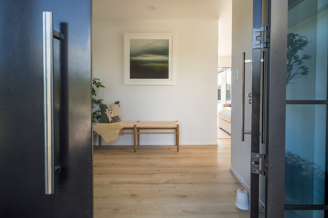 AFTER: A modern, warm and inviting entranceway with seamless flow into the living areas.