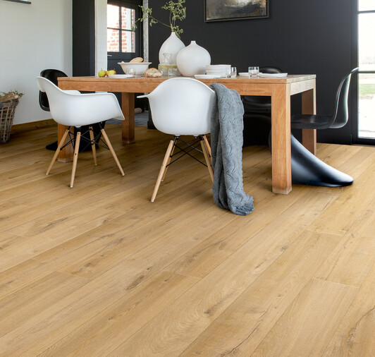 Natural Oak Laminate Flooring in a dining room with white chairs and oak table