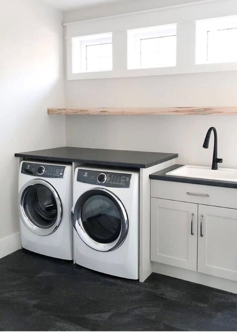 A black hybrid floor in a white laundry area.