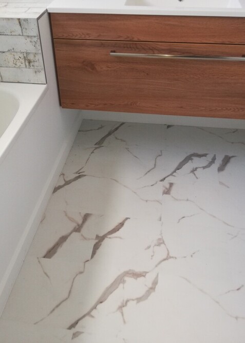 White Marbled Hybrid floor in a bathroom.