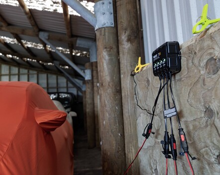 Vehicle connected to battery charger in PB Group indoor storage
