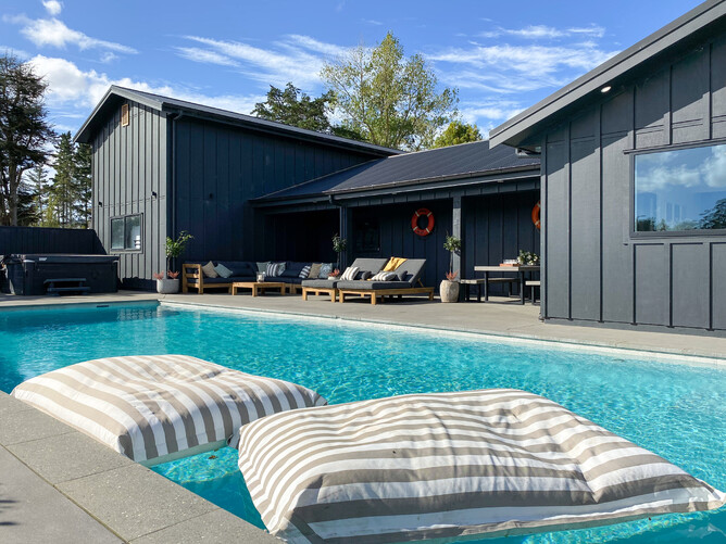 A pool pavilion with bean bags floating in the pool