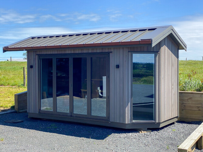Cabin exterior showing cedar cladding and Euro tray roof