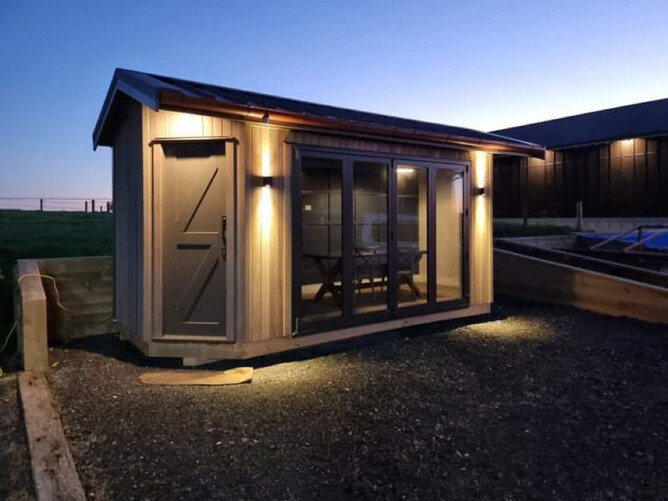 Cabin lit up at night showing feature up/down lights and the interior illuminated