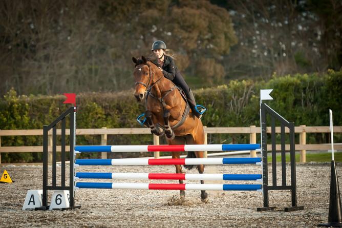 Sacha Thomas and her horse Kiwi Fern jumping in the arena