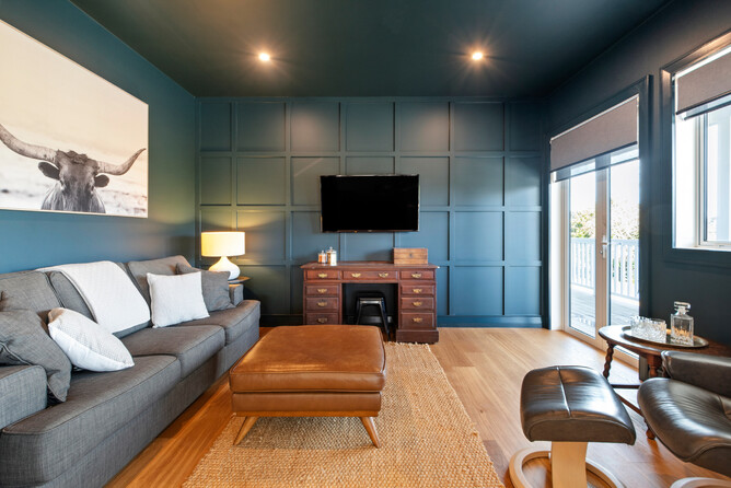 Deep blue wall feature in the media room