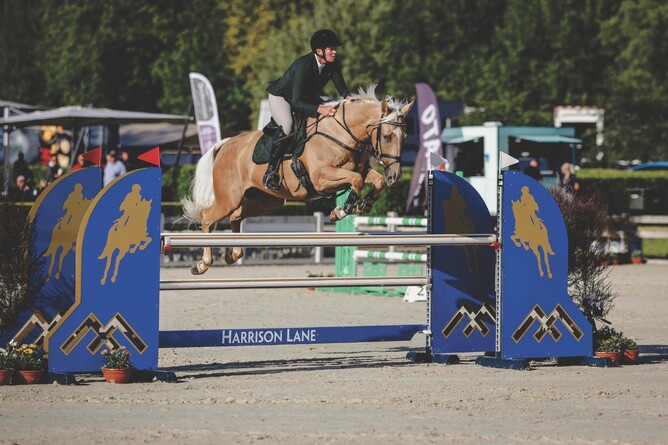Elise Edwards-Smith and her lovely gelding DSE Gotta Legacy jumping the Harrison Lane fence