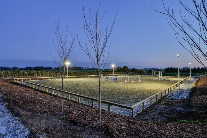 Ebb and flow arena lit up at night under flood lights