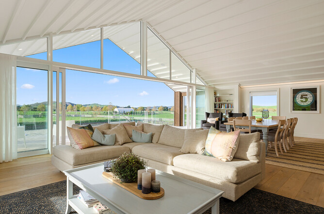 Living area that looks out to covered deck surveying the arena