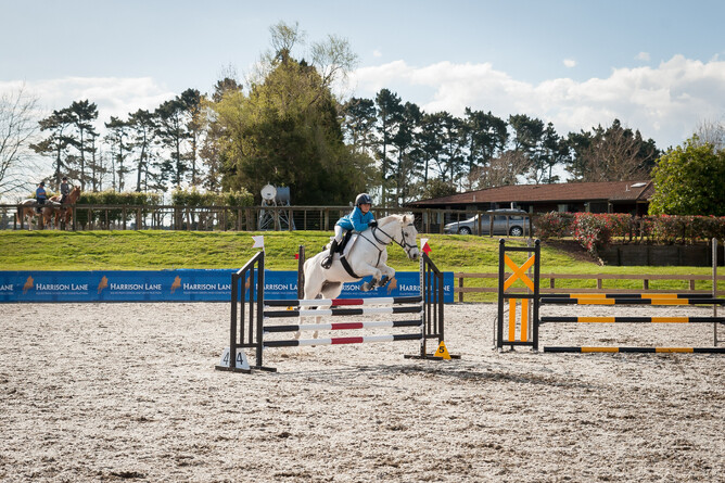 William Moore jumping his pony Molly in the arena