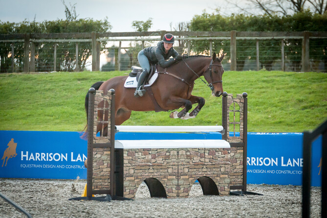 Leeshelle Small and AMS Dolce NZPH jump a fence in Abderry's Ebb & Flow arena