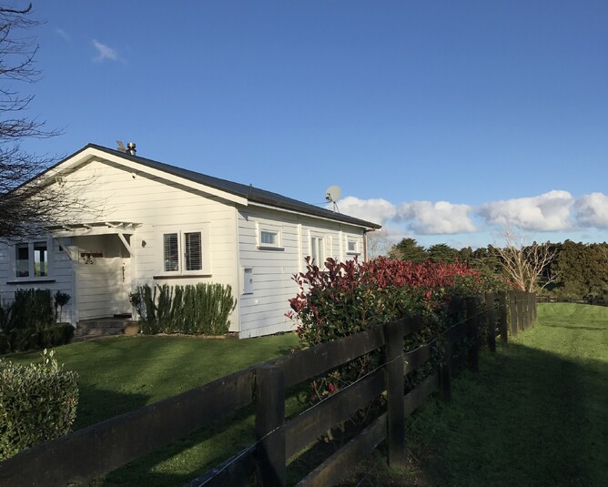A view of the original cottage on site with a view from the garden