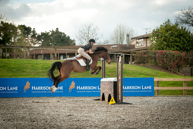 Maddy Cutfield jumping a fence on Hidden Warrior