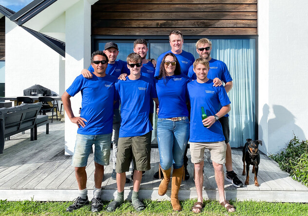 Harrison Lane team standing in front of country home deck