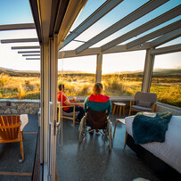 Glass-roof cabin interior opening onto a private deck at SkyScape