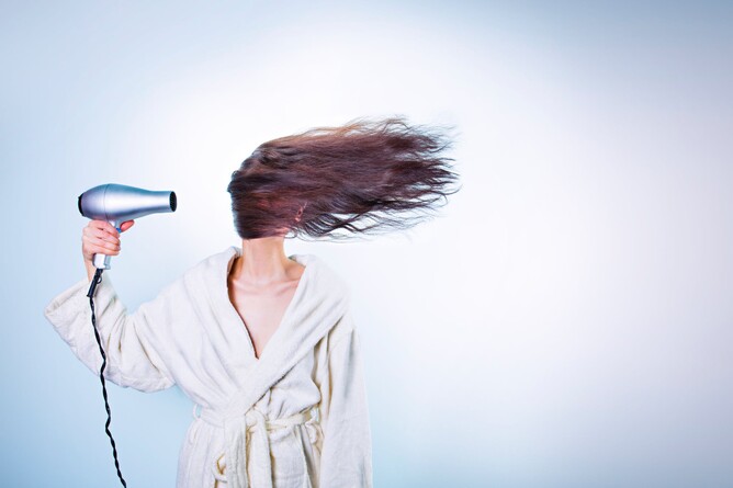 Woman with hairdryer 