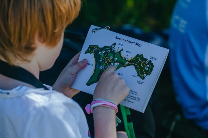 Image of a young boy reading a map at Rotoroa Island’s Education Programme. Supported by The Jenkins Foundation. New Zealand.