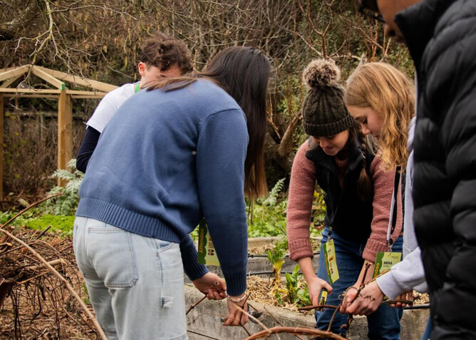 EnviroPAST: Plastic And Sustainability Talks, is a two-day conference funded by The Jenkins Foundation. New Zealand. Image of students gardening in community garden.