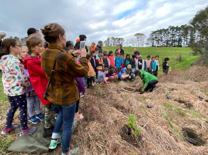 Trees For Survival Coordinators demonstrate planting technique