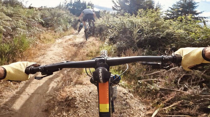 Greg following Jeremy along the jumps on Ye Old Mill Road while heading towards Rakehead