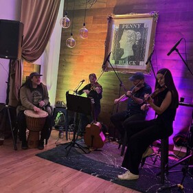 Erica and a band playing live at an event.