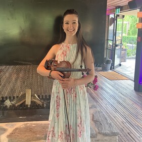 Erica and her violin ready to play at an event.