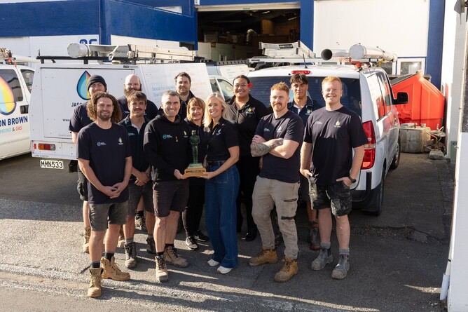 Jason Brown Plumbing & Gas team celebrating 20 years in business, standing together in Wellington.