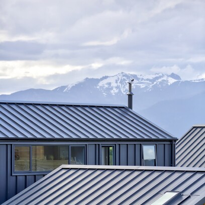 Looking out over the alpin tray rooflines of the house towards the mountains.