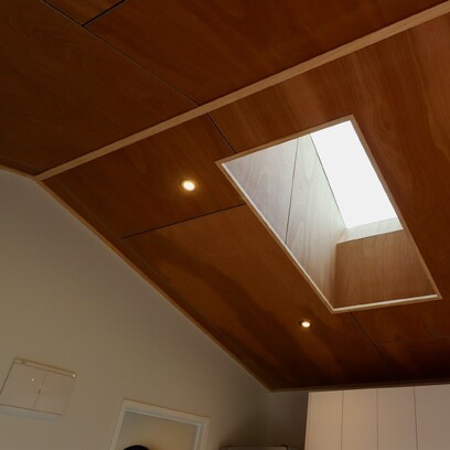 Timber ceiling with a skylight allowing ample natural light into the home.