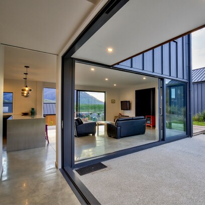 Extra large stack sliding doors looking into the kitchen and living area of the home.