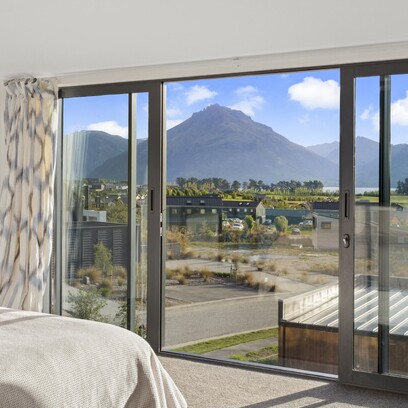 The view looking out from the upstairs bedroom out into Jacks Point with the mountains in the background.