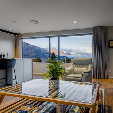 The view looking out through the lounge out the window towards the Queenstown mountains and Lake Wakatipu.