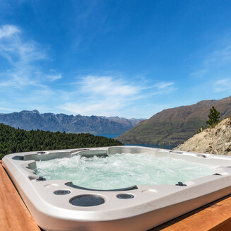 A front, side view of the home extension. The home is clad in Luna timber cladding with dark colour steel roof, and a timber deck in front.