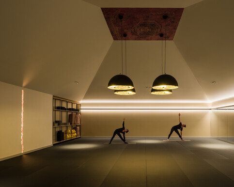 a photo of two people practising yoga in the Fire Studio