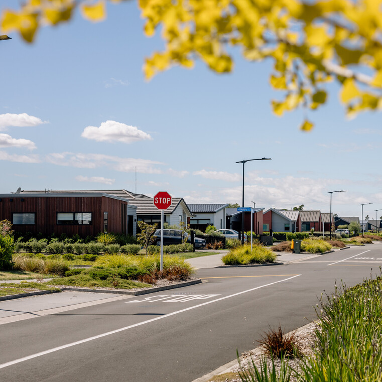four way road with stop sign and a street with homes
